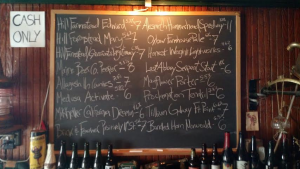 The Dive Bar's handwritten tap list adds to the venue's overall vibe.